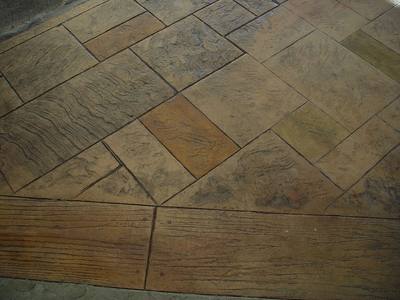 Finished stamped concrete patio in an ashlar slate pattern with a wood-plank border